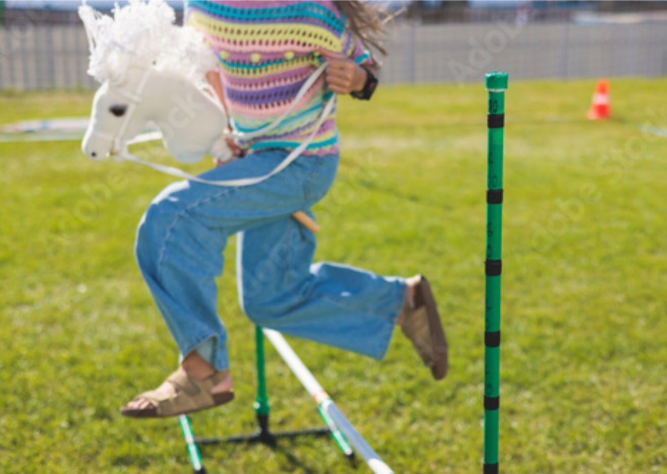 Child racing a stick horse
